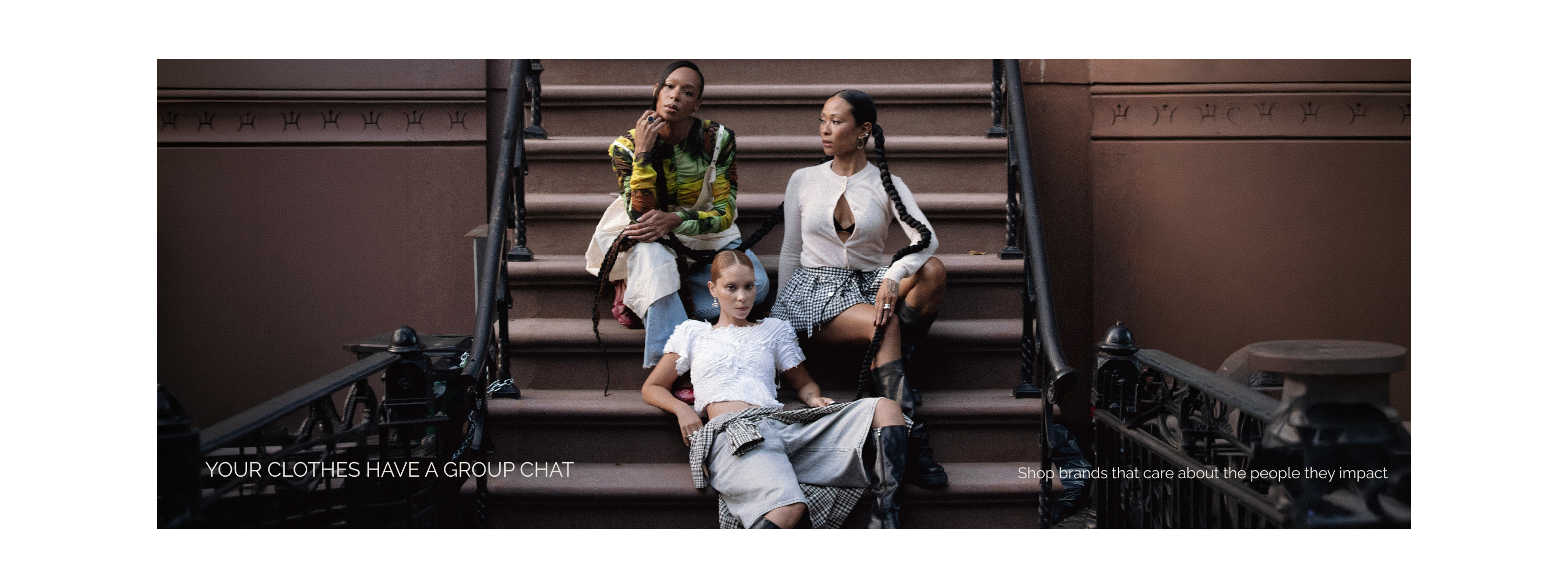 Three women sitting on a set of stairs with text about ethical fashion 