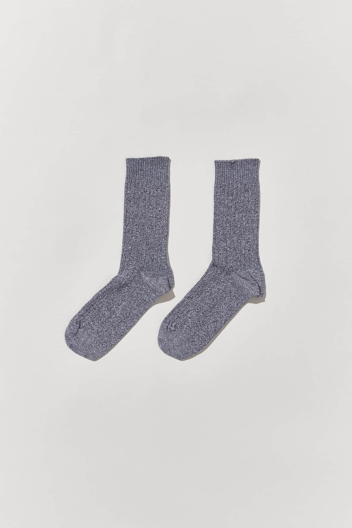 A pair of grey socks over a white background