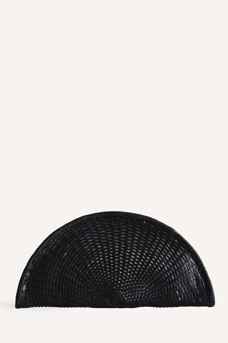 Black woven half-circle object on a white background