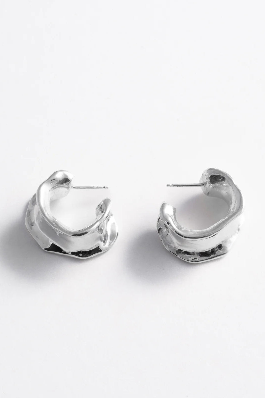 Pair of silver hoop earrings on a white background