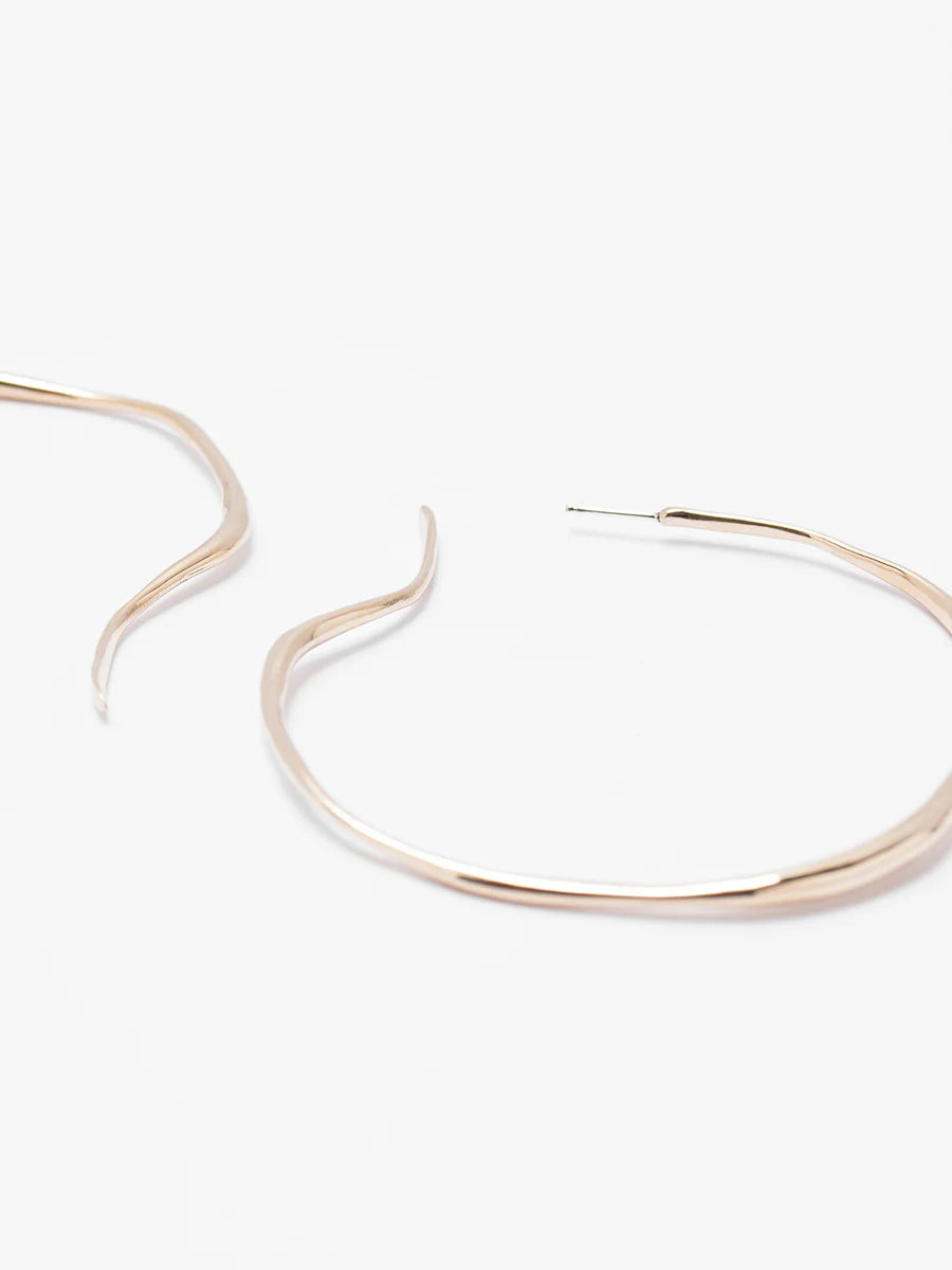 Gold hoop earrings on a white background