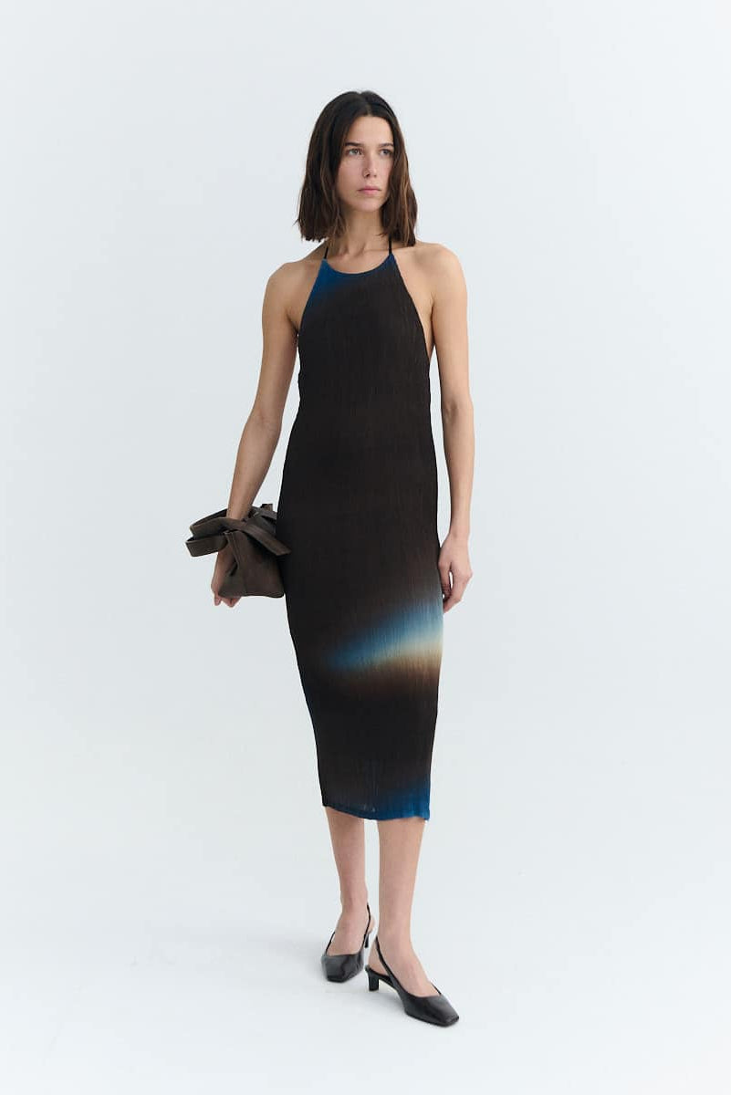 Woman wearing a black and blue gradient dress on a white background